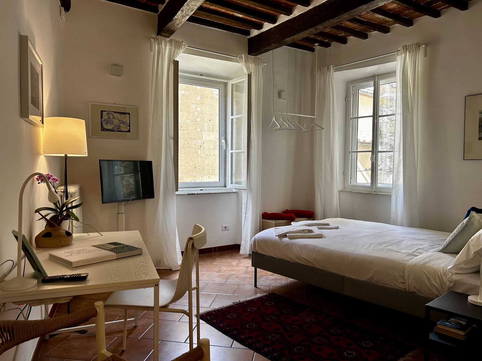 The Boutique Apartment — bedroom in warm afternoon light.