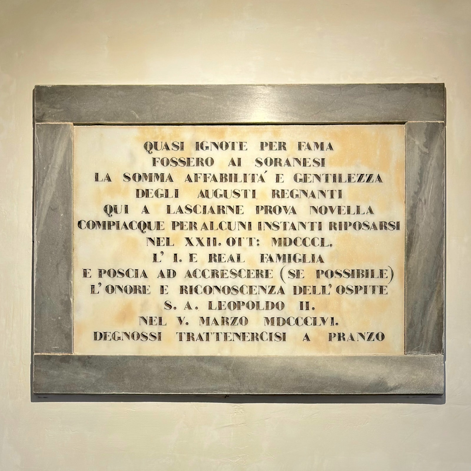 A marble plaque at Palazzo Palloni recording two visits by Grand Duke Leopold II of Tuscany, in 1850 and 1856.