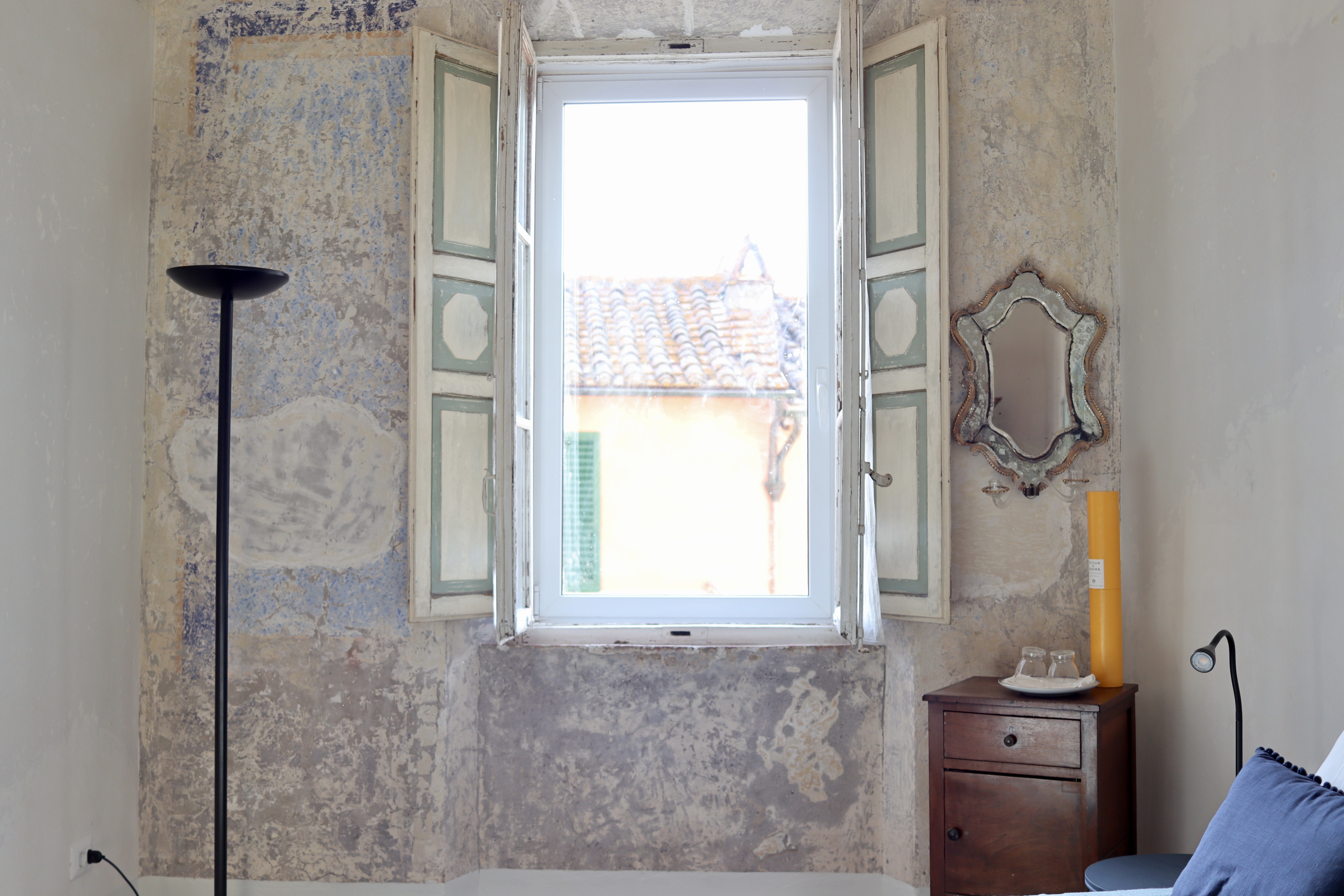 Bedroom with exposed stone and limewashed walls.